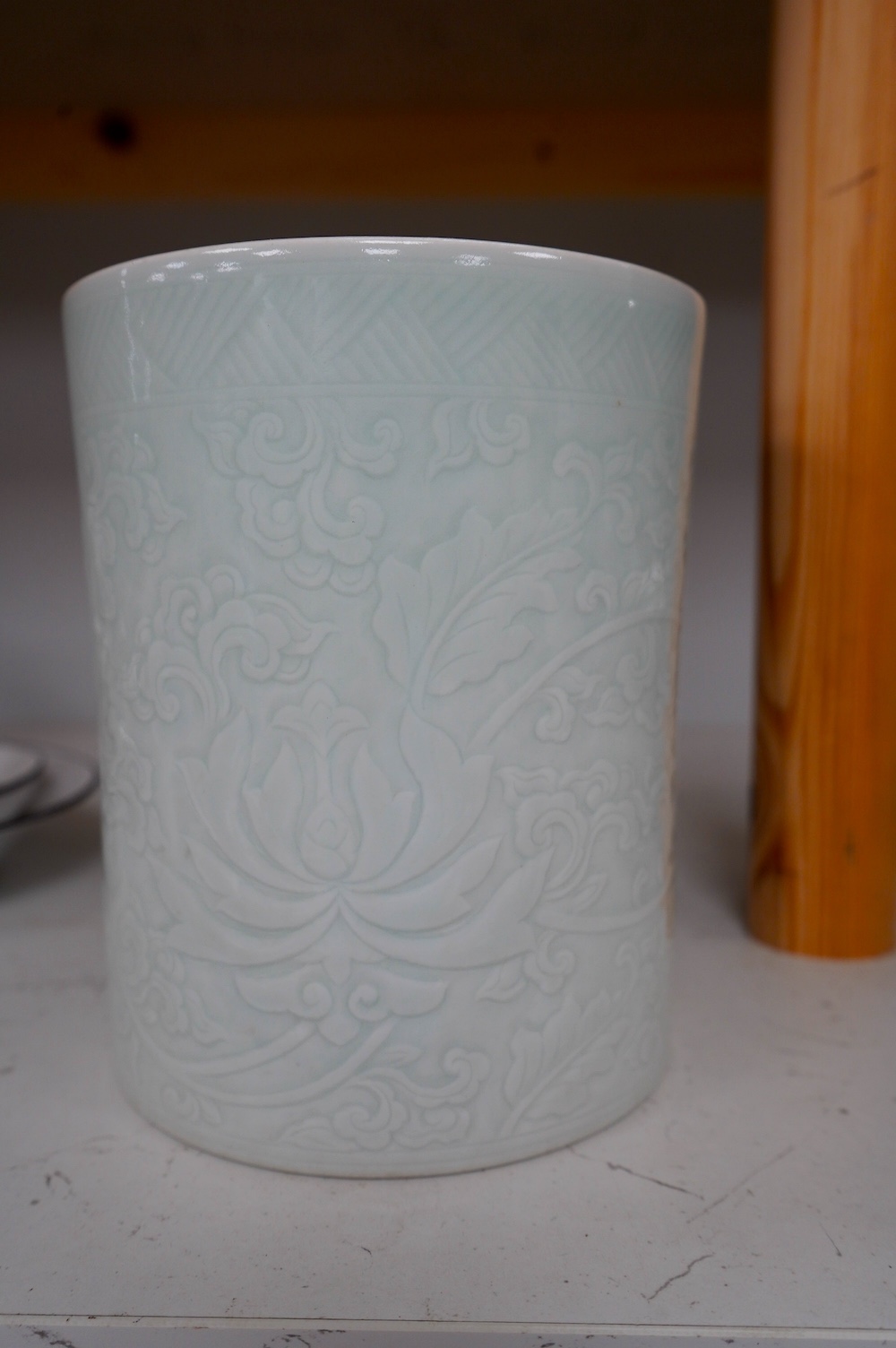 A Chinese celadon glazed brush pot, Kangxi style, 15.5cm high. Condition - good